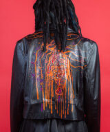 spark and rebel features wild orange upcycled leather jacket in eco fashion