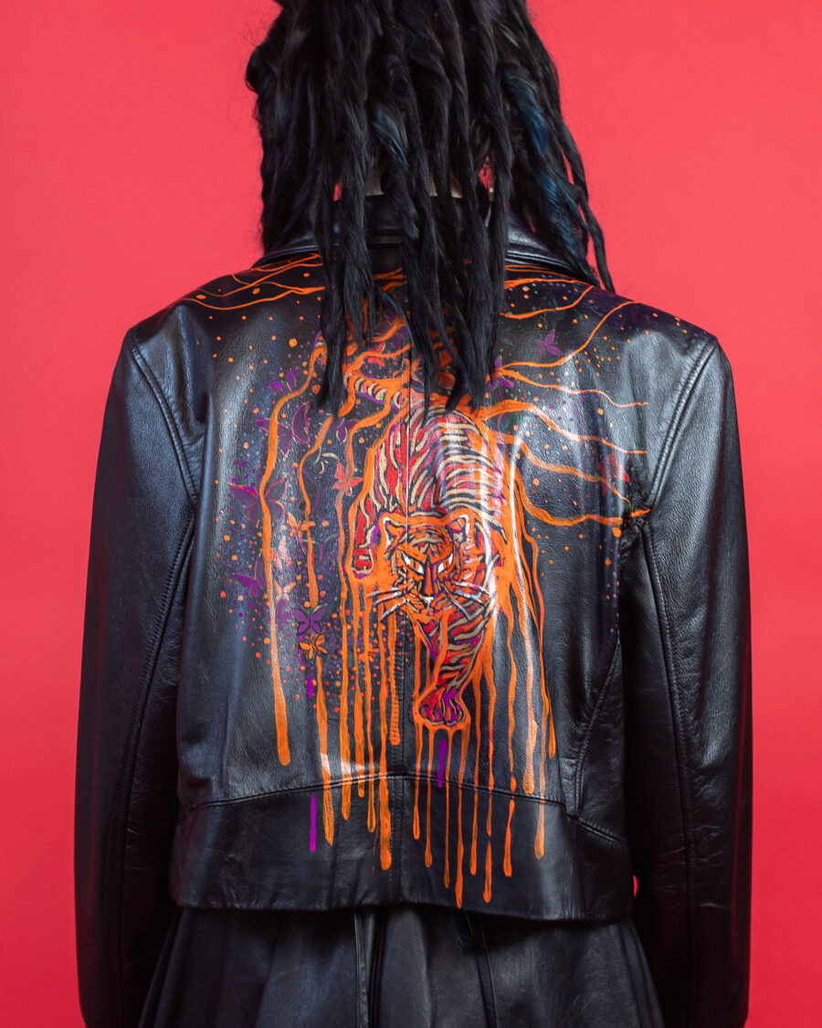 spark and rebel features wild orange upcycled leather jacket in eco fashion